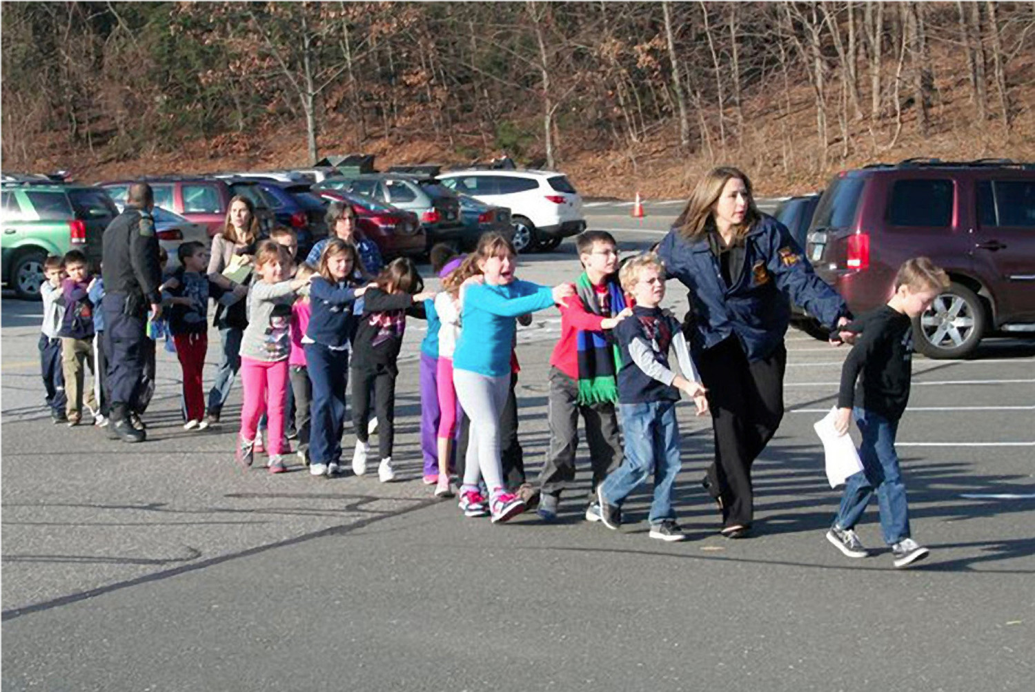 HO  421726.JPG HO  1C257A51 HO  1C223C14 Dec 14, 2012 - Newtown, Connecticut, U.S. - State police personnel lead children from the Sandy Hook Elementary School in this handout picture from the Newtown Bee, in Newtown, Connecticut, December 14, 2012. All public schools in Newtown, Connecticut, were placed in lockdown on Friday following a shooting at Sandy Hook Elementary School. An official with knowledge of a shooting at a Connecticut elementary school says 27 people are dead, including 18 children. The official spoke on condition of anonymity because the investigation is still under way. (Credit Image: © Shannon Hicks/Newtown Bee/ZUMA24.com)